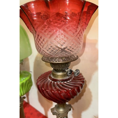 429 - Antique Brass Corinthian Based Oil Lamp with Ornate Ruby Glass Reservoir & Ruby Fluted Shade