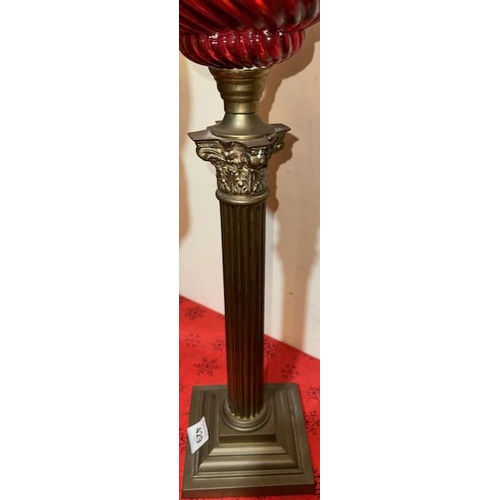 429 - Antique Brass Corinthian Based Oil Lamp with Ornate Ruby Glass Reservoir & Ruby Fluted Shade