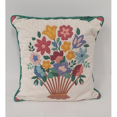 92 - Pair of cushions 1 depicting a bouquet of summer flowers the other in red with Latin script