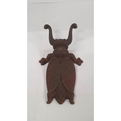 28 - Cast iron door stop / garden ornament in the style of a beetle