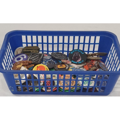 33 - Blue basket containing a large collection of pin badges, many music group related