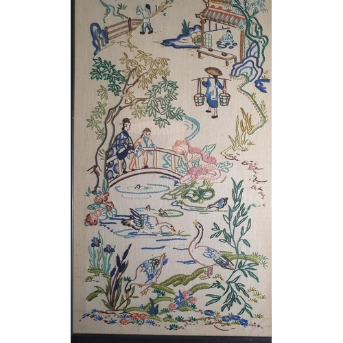 432 - Tall framed and glazed Japanese needlework art depicting village scenes