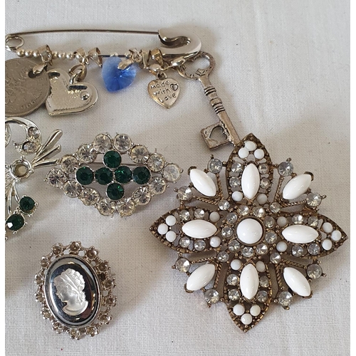 195 - Group of white metal jewellery items, including cameo style brooch and safety pin pendant holder