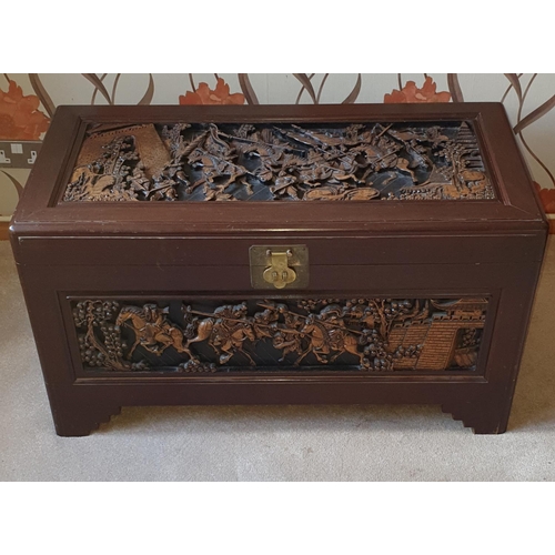 481 - Large profusely carved oriental Camphorwood Chest depicting a battle scene (slight damage)