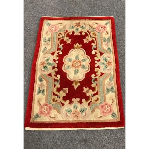 96 - Small deep pile wool rug with symmetrical floral design, 24