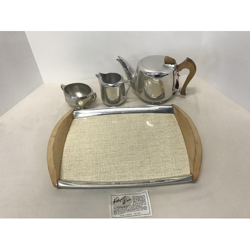 56 - A collection of Piquot ware consisting of tray, Milk Jug, Teapot and 2 handled bowl