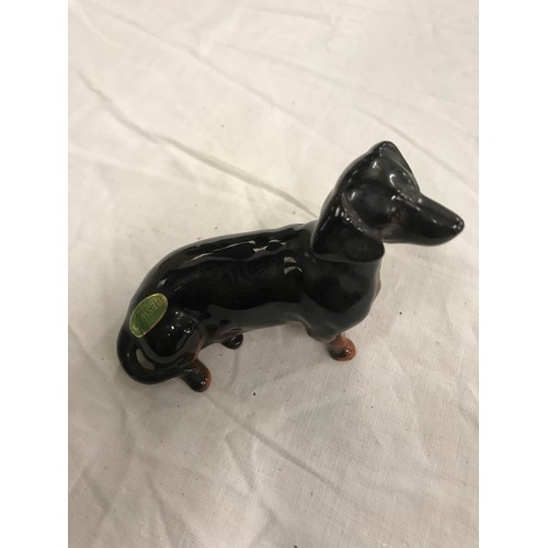 42 - Two dachshund, 1 by Beswick and 1 resin