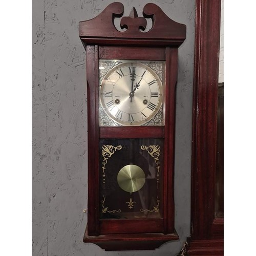 106 - Mahogany finish wind up wall clock