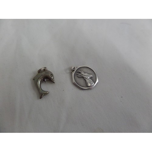 34 - Two silver pendants, 1 dolphin and 1 gazelle