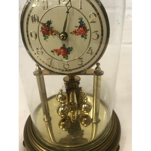 57 - Vintage German brass anniversary clock under glass dome, cream coloured dial with Arabic numerals an... 