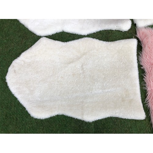 107 - Four fluffy floor mats in sheep skin effect