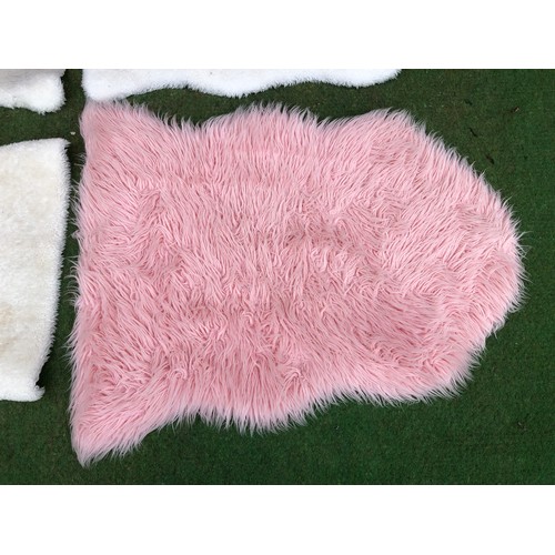 107 - Four fluffy floor mats in sheep skin effect