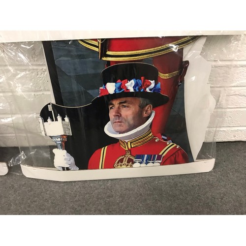 25 - Two packaged large cardboard cut outs of Queen and a beefeater