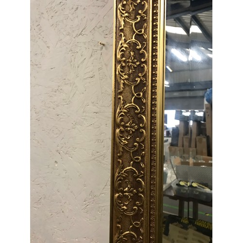 119 - Heavy ornate gold coloured framed bevel edged mirror