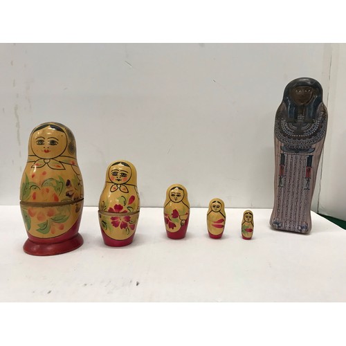 143 - Russian five peice wooden doll set and Egyptian  tin