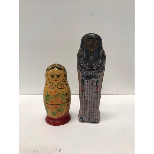 143 - Russian five peice wooden doll set and Egyptian  tin