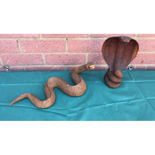 33 - Two carved figures of snakes