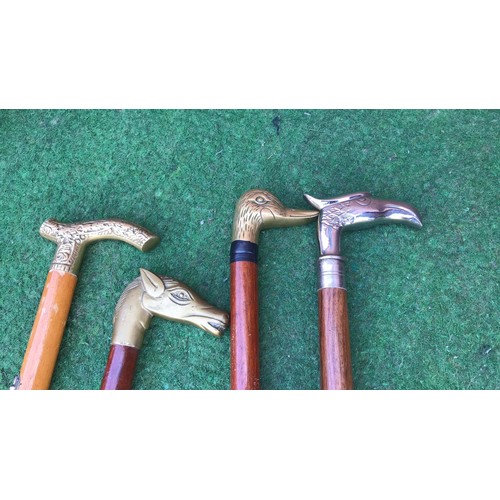 56 - 4 walking sticks with mixed metal carved heads