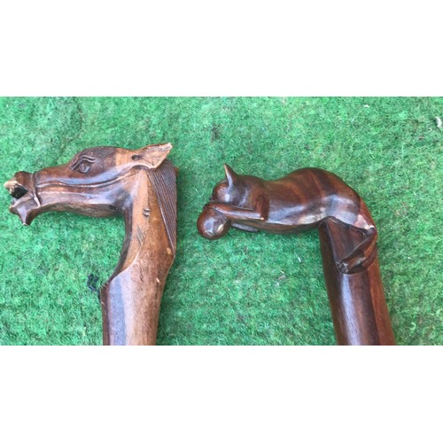 67 - 2 wooden carved walking sticks