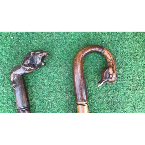 65 - 2 wooden carved walking sticks ( see condition report )