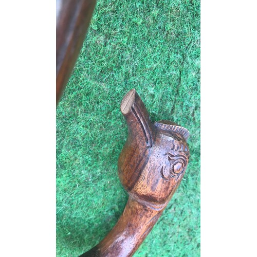 65 - 2 wooden carved walking sticks ( see condition report )