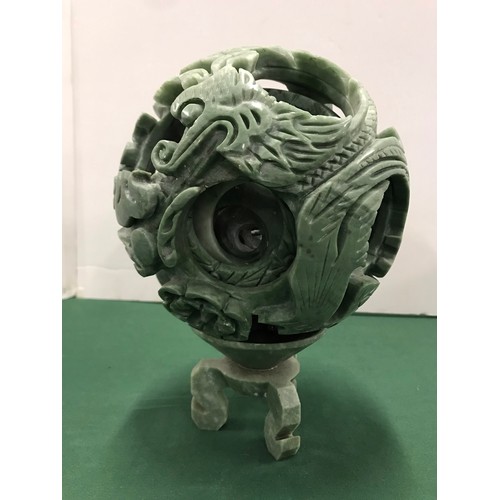 257 - Green soap stone One piece Puzzle ball with Dragon Motive on standsee pictures