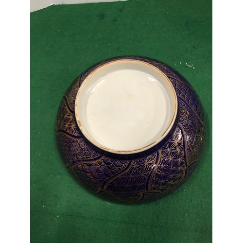 272 - Round oriental bowel with white inside floral detail and sale detail to outer side in purple