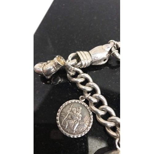 170 - Silver heavy charm bracelet with eagle clasp & 7 charms weight 99.98g