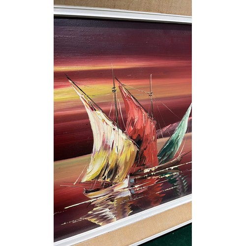 435 - LARGE RETRO FRAMED ART WORK OF SAILING BOATS UNDER THE RED SKY IN OIL SIGNED