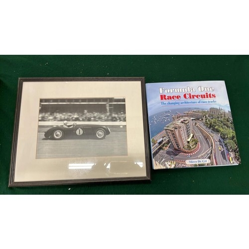 11 - FRAMED STIRLING MOSS DRIVING THE JAGUAR C TYPE AND RACING BOOK