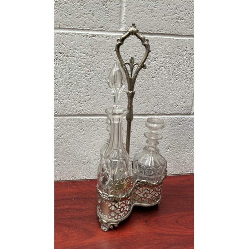 96 - METAL TANTALUS WITH THREE CLEAR GLASS DECANTERS AND COLLARS