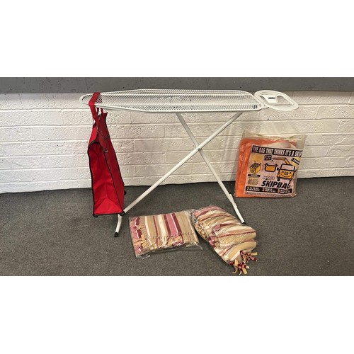 300 - IRON BOARD , RED SHOPPING TROLLY AND BED COVERS PLUS SKIP BAG