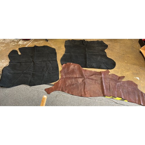 281 - THREE LARGE LEATHER HIDES IN BLACK AND BROWN