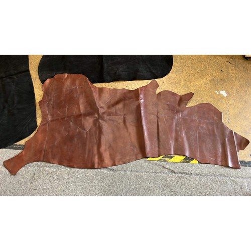 281 - THREE LARGE LEATHER HIDES IN BLACK AND BROWN