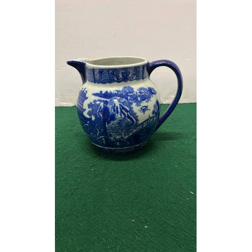 64 - LARGE IRONSTONE BLUE AND WHITE WILLOW PATTERN JUG