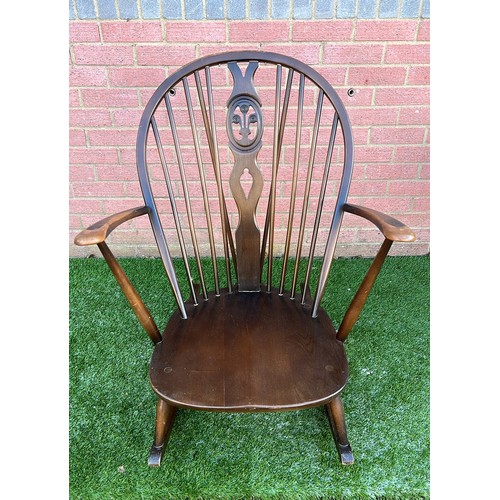 134 - ERCOL DARK FINISH LOW ROCKING CHAIR WITH WARE SEE ALL PICTURES