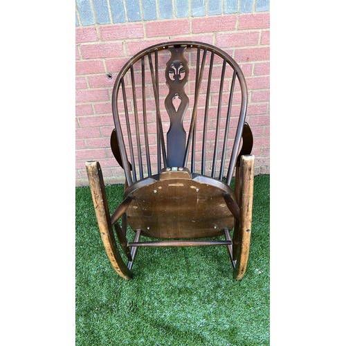 134 - ERCOL DARK FINISH LOW ROCKING CHAIR WITH WARE SEE ALL PICTURES