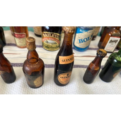 21 - QTY OF MIXED MINIATURE BOTTLES OF ALCOHOL H/C UNCHECKED