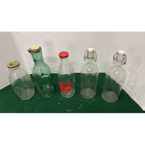 143 - FIVE ASSORTED GLASS MILK BOTTLES