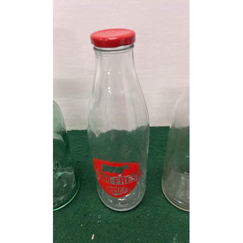 143 - FIVE ASSORTED GLASS MILK BOTTLES