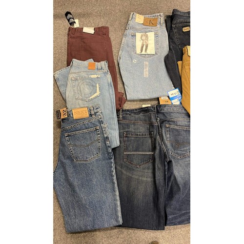 334 - 9 PAIRS OF JEANS IN MIXED COLOURS SIZE 32 WITH TAGS