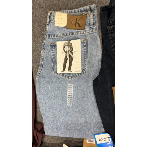 334 - 9 PAIRS OF JEANS IN MIXED COLOURS SIZE 32 WITH TAGS