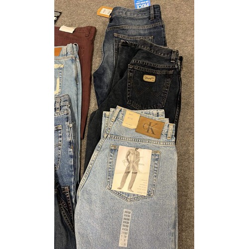 334 - 9 PAIRS OF JEANS IN MIXED COLOURS SIZE 32 WITH TAGS