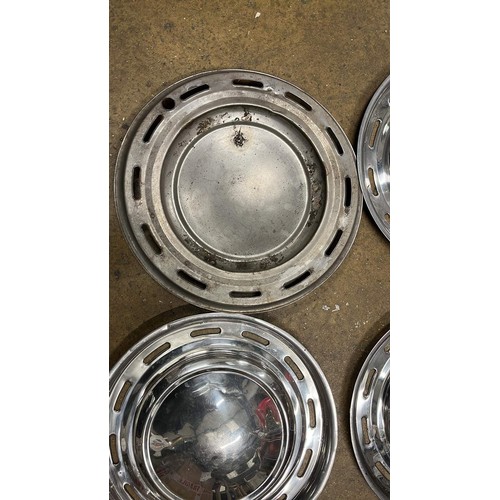 598 - FOUR VINTAGE WHEEL HUB CAPS