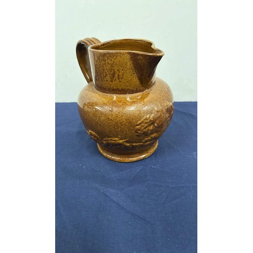 76 - GLAZED EARTHEN WARE WATER JUG WITH HUNTING SCENE