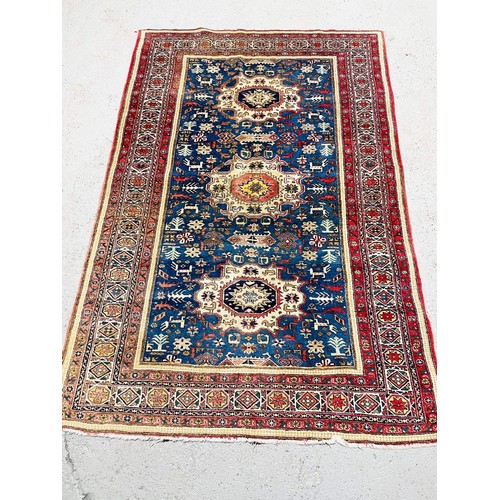 46 - RED AND BLUE PATTERN OVER RUG 211cm x 140cm