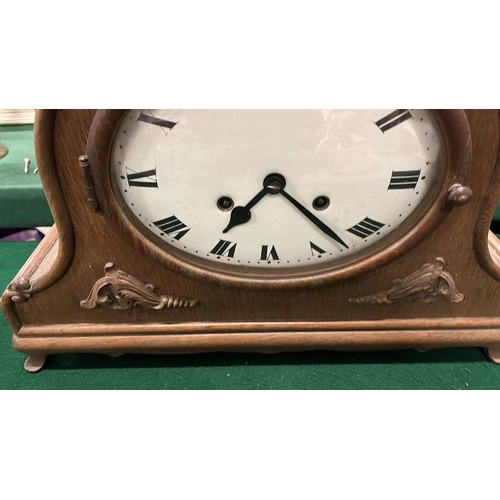 382 - LARGE OAK CASED HELMET SHAPED MANTLE CLOCK WITH ENAMEL FACE WORKING