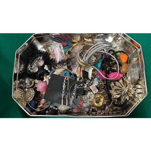 894 - TIN OF COSTUME JEWELLERY