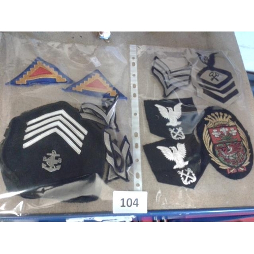 104 - Quantity of assorted cloth military badges and stripes