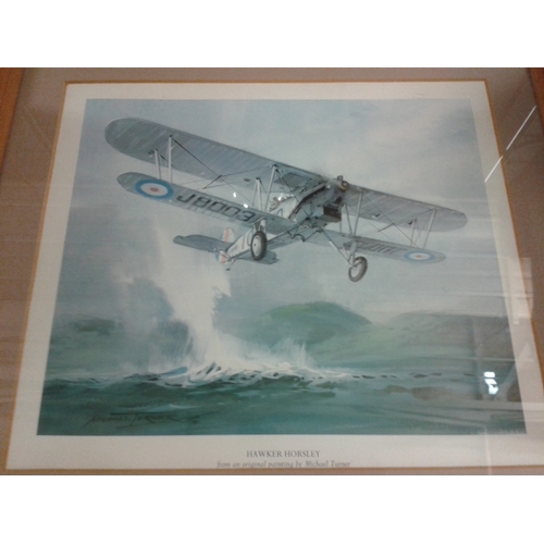 131 - Framed and mounted picture print of a Hawker Horsley biplane by Michael Turner, large amount of warp... 